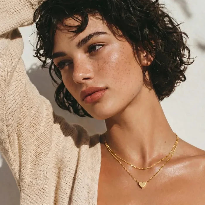 Layered Heart Necklace in gold-tone metal with two fine chains, one beaded, and a small polished heart pendant.