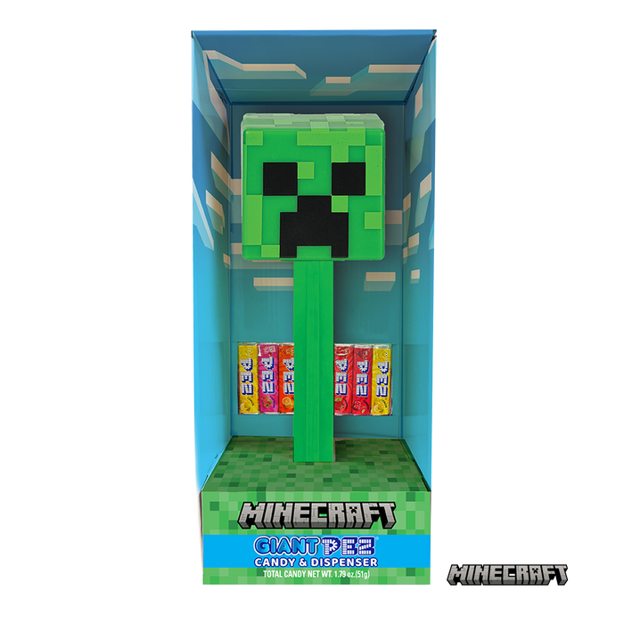 Minecraft Creeper Pez candy dispenser in its original blue window box packaging, featuring a green Creeper head dispenser and six colorful candy bars inside.