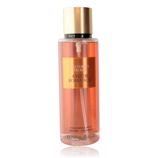 Amber Romance fragrance mist in a clear bottle with amber-pink liquid, gold cap, and gold label.