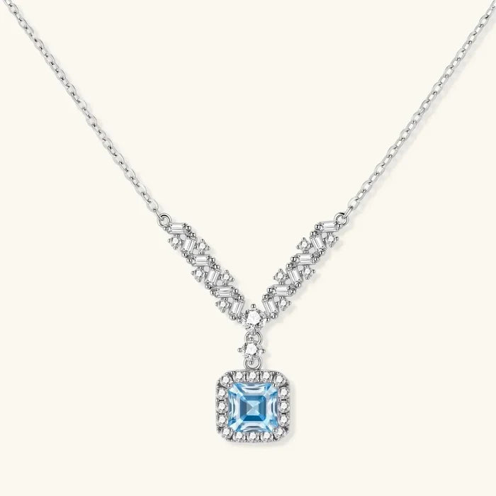 Celestial Arc Moissanite Necklace in silver with baguette and round stones, featuring a square blue centerpiece and pavé halo