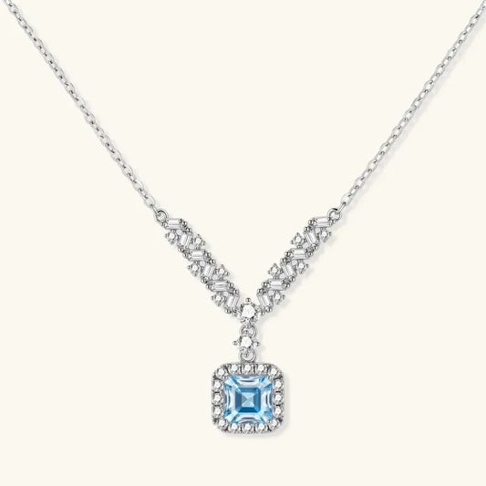 Celestial Arc Moissanite Necklace in silver with baguette and round stones, featuring a square blue centerpiece and pavé halo