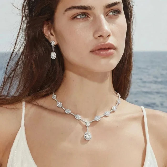 Celestial Cascade CZ Necklace set in silver-tone metal with sparkling round stones, Y-shaped pendant and matching drop earrings