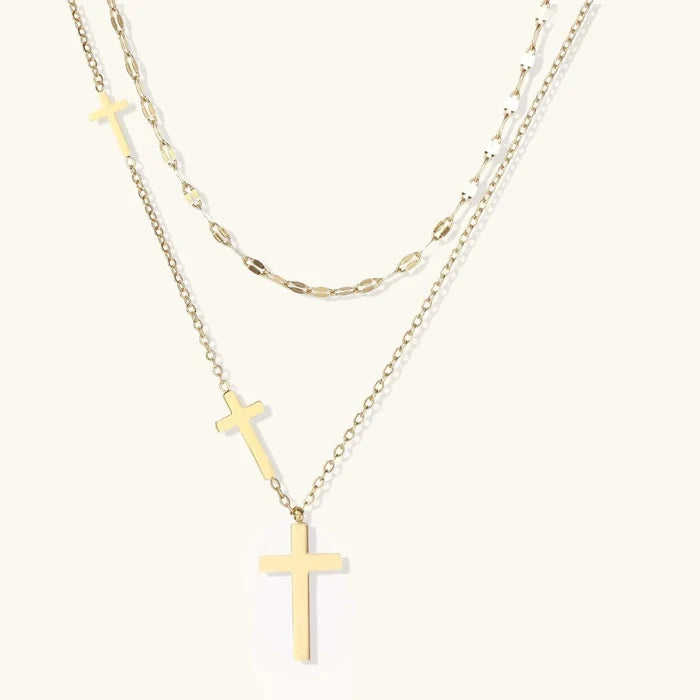 Divine Layers Cross Necklace Set featuring two gold-tone chains, a faceted link accent and three graduated polished cross pendants
