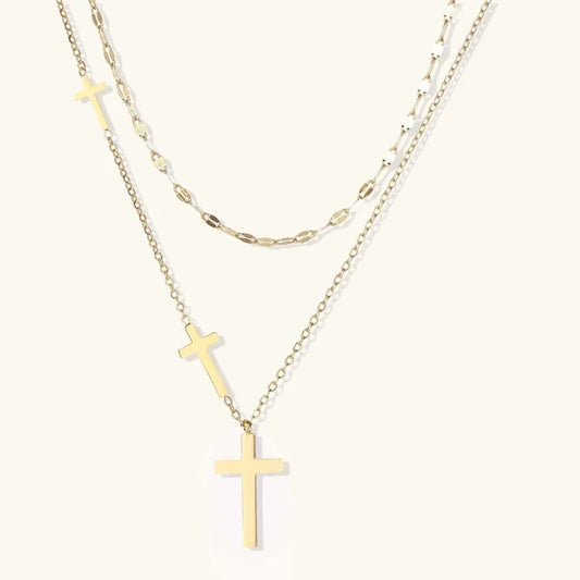 Divine Layers Cross Necklace Set featuring two gold-tone chains, a faceted link accent and three graduated polished cross pendants