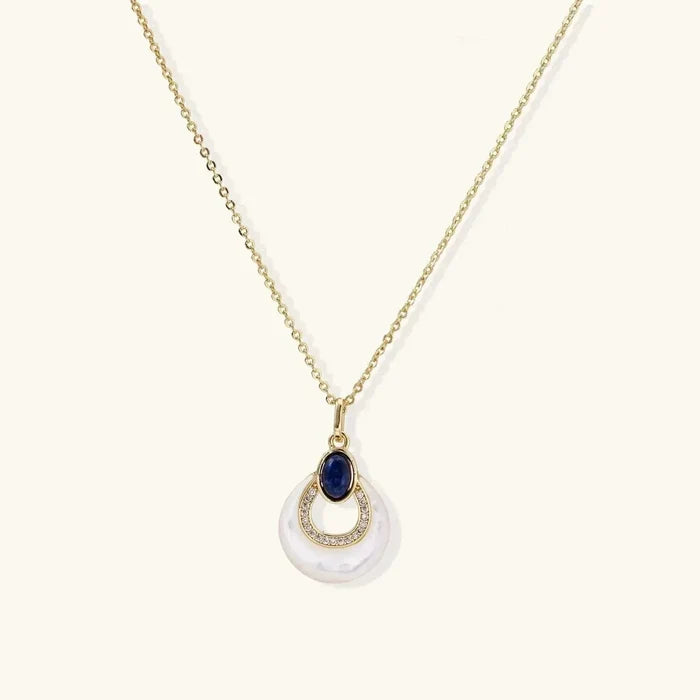 Mystic Mother-of-Pearl & Lapis Lazuli Necklace with a gold-tone chain, blue oval stone, pavé ring and iridescent pearl disc