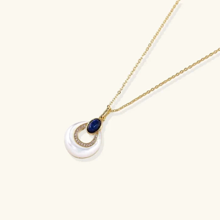 Mystic Mother-of-Pearl & Lapis Lazuli Necklace with a white iridescent pendant, deep blue stone and gold-tone pavé ring