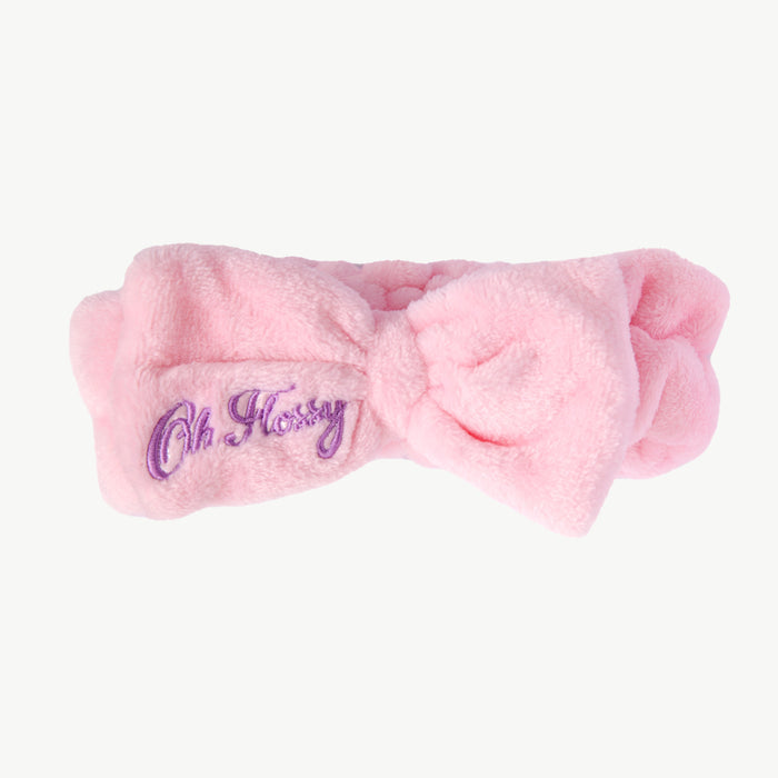 Pink fuzzy headband with 'Oh Flossy' logo on a white background