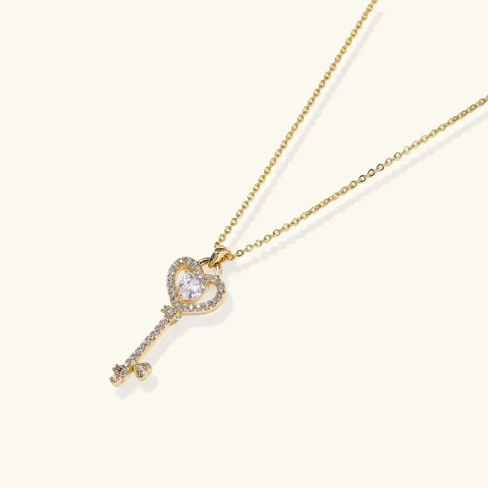 Secret Heart Key Necklace in gold-tone metal, featuring a heart-shaped key pendant with clear sparkling stones