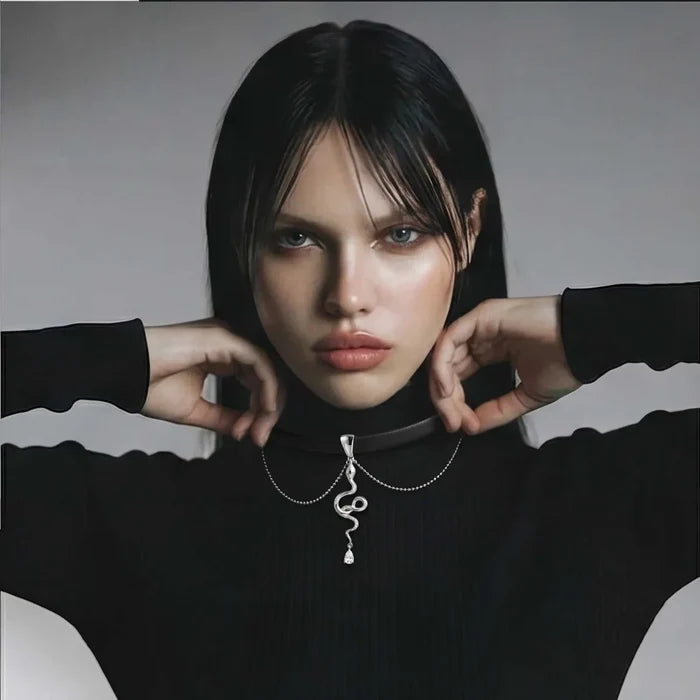 Serpent Power Black Suede choker with a black cord, silver-tone coiled serpent pendant, zirconia drop and draped chains